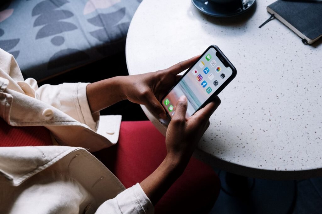 Person browsing a directory listing on a smartphone in a cafe