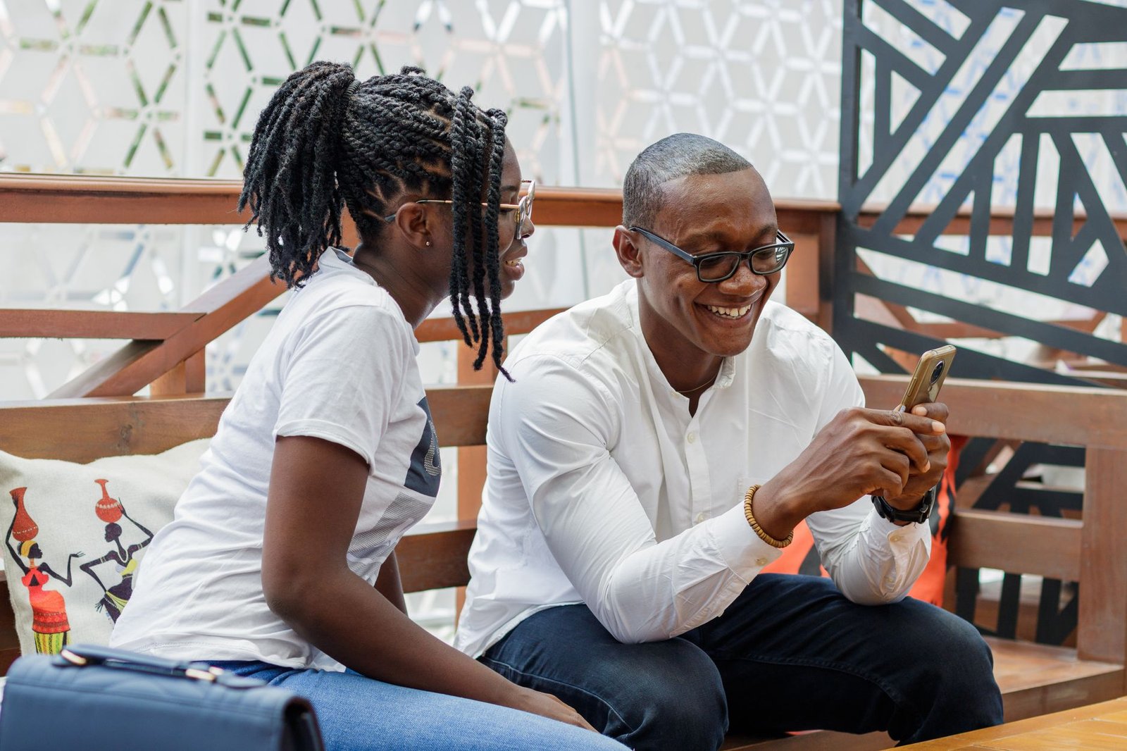 Adults reviewing profile information on a smartphone in Accra