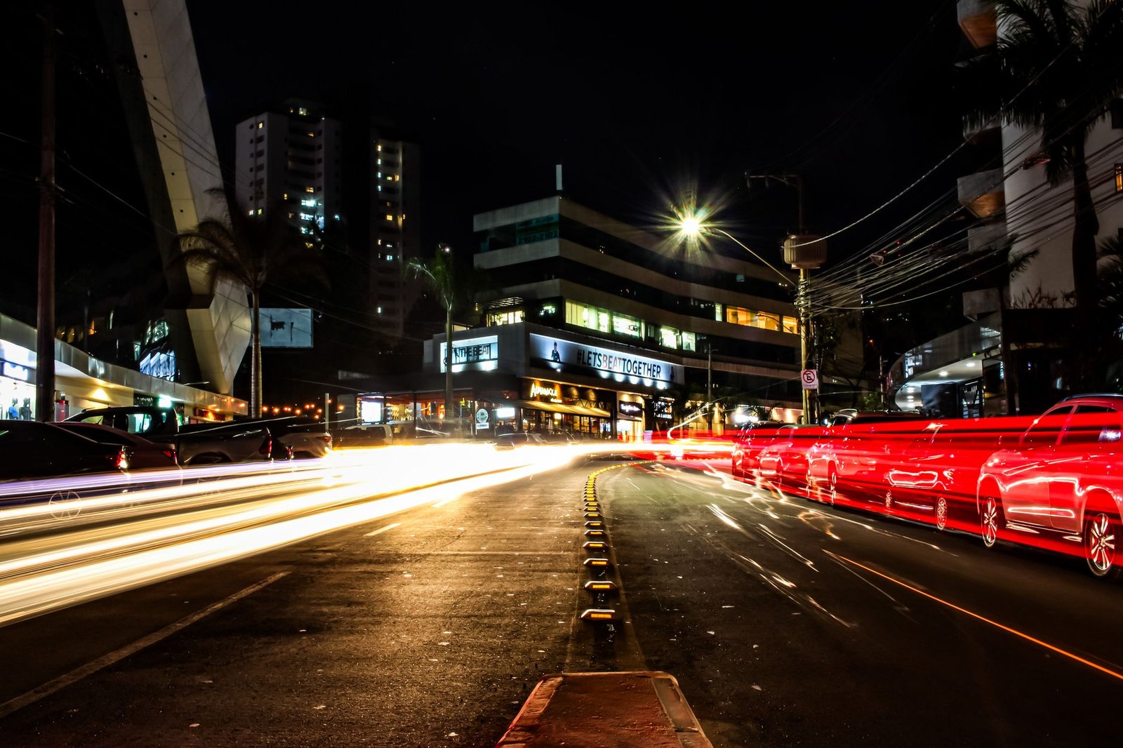 Vibrant light trails on a busy night street in Belo Horizonte, Brazil, showcasing urban energy.