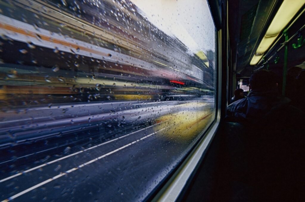 tram, bus, raindrops, glass window, transportation, urban, street, city, vehicle, speed, road, traffic, window, downtown, bus