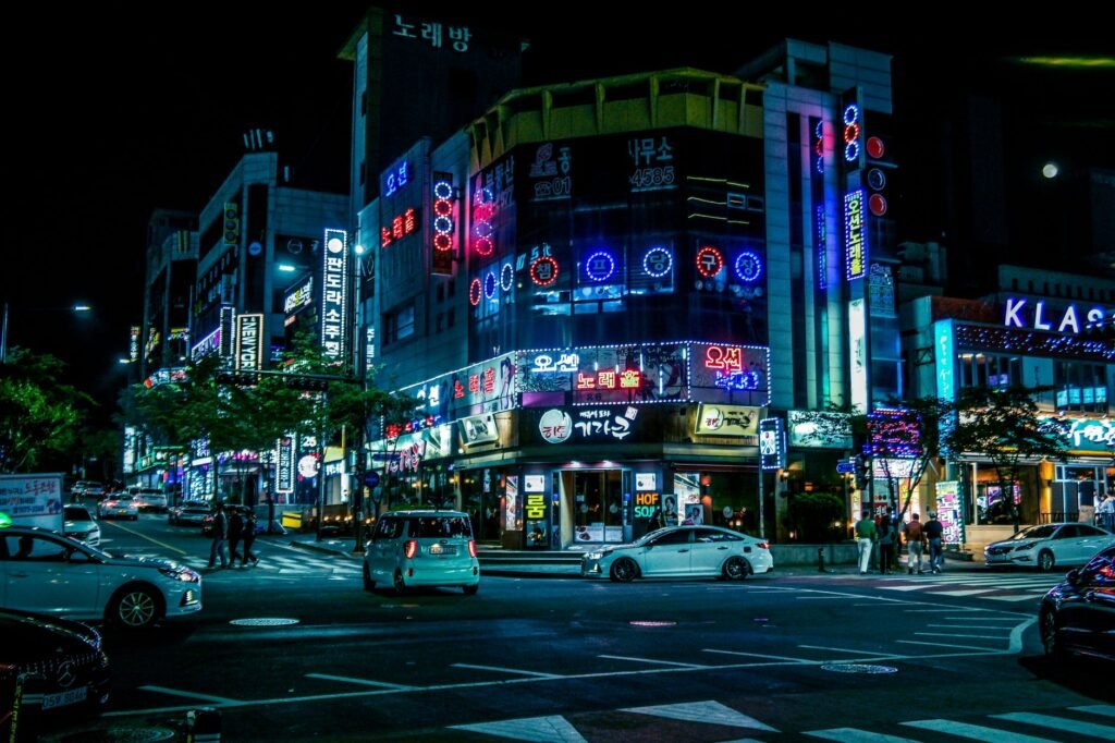 Illuminated street in Gwangju, South Korea, showcasing neon lights and city hustle at night.
