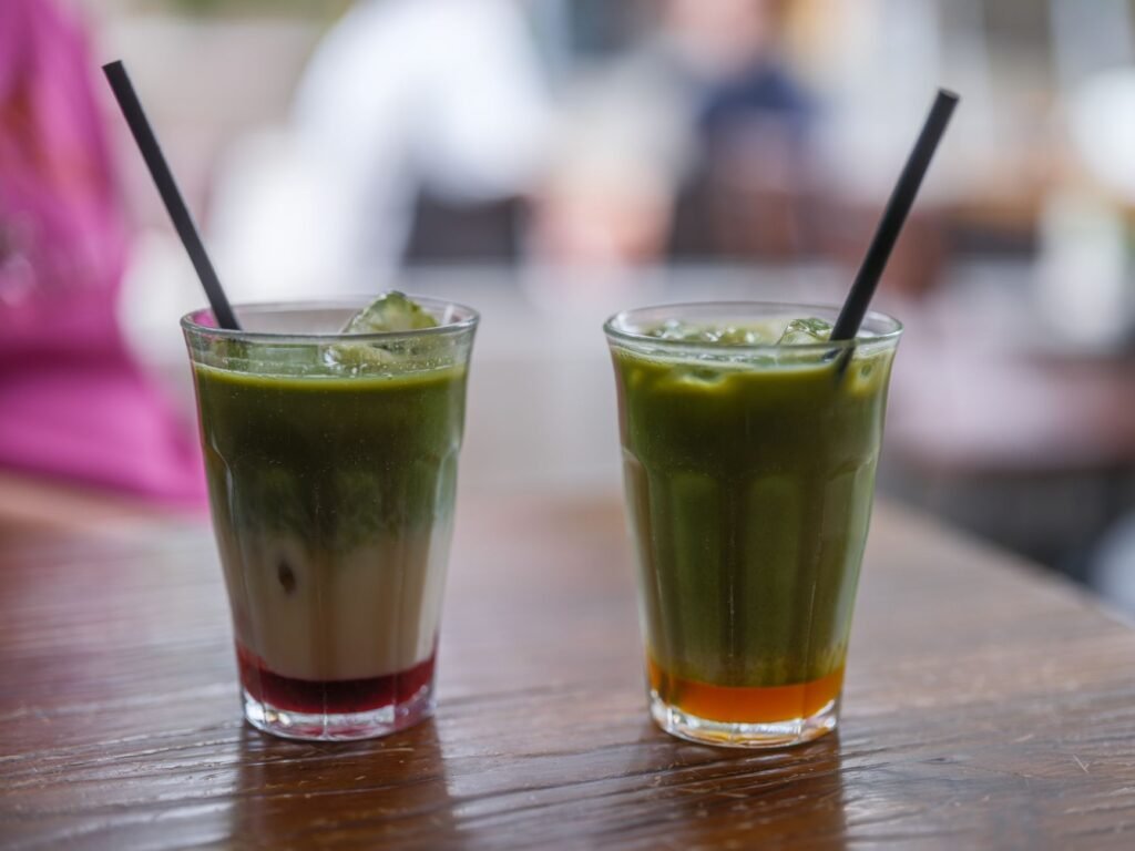 Two drinks on a cafe table in the early evening, a neutral setting for a first meeting