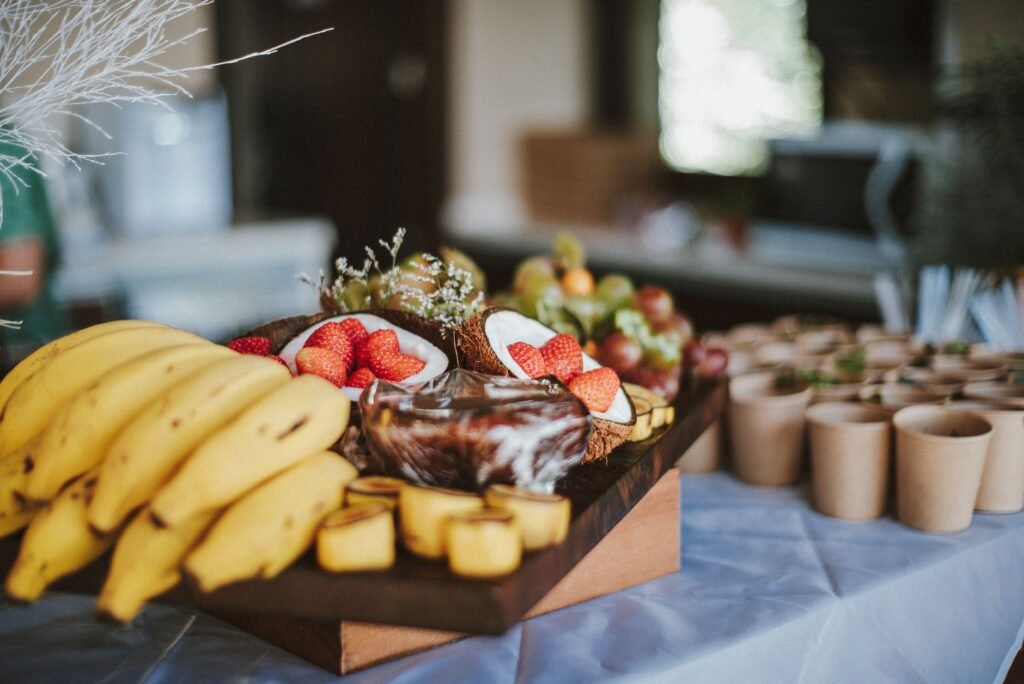 Snack plate with groundnuts, plantain and fruit for shared dining