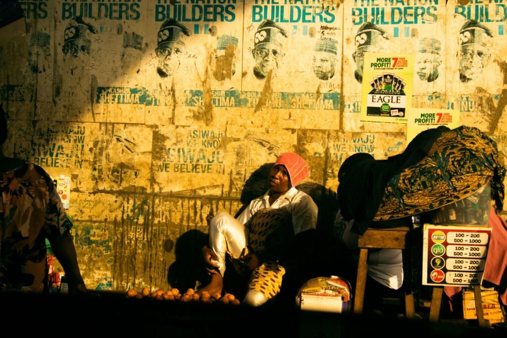 Afternoon street scene in a small Ghanaian market town with stalls and pedestrians