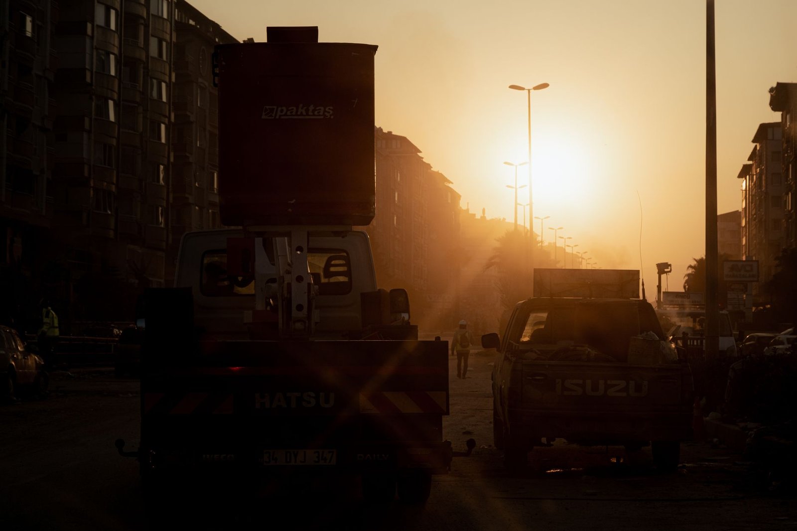 Quiet street in a Ghanaian town during golden hour with people walking