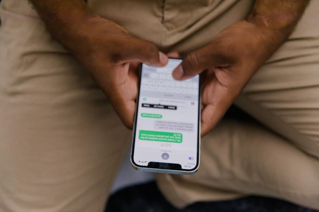 Hands typing a respectful opening message on a phone next to a cup of tea