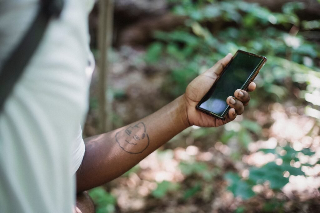 A person browsing a listing directory on a smartphone outdoors