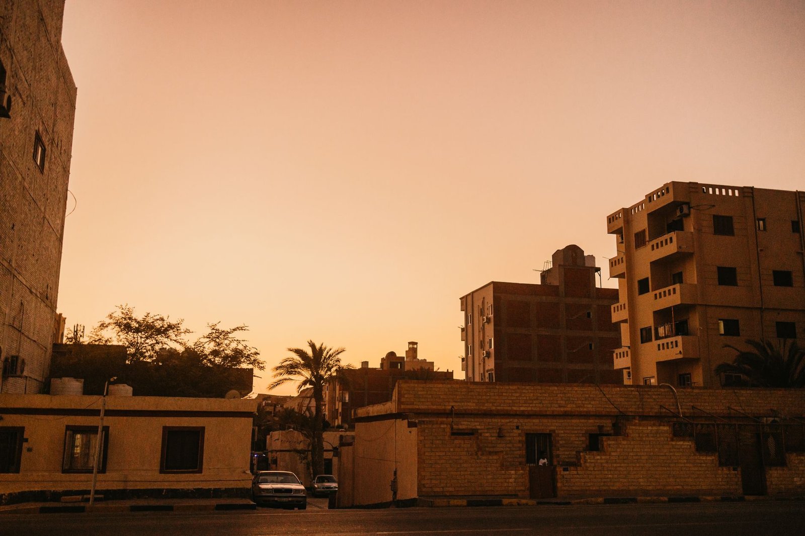 Quiet street in a northern Ghanaian town at dusk with soft warm light