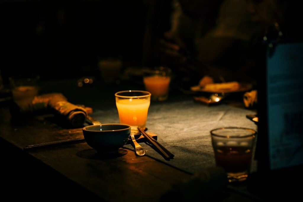 Two adults in smart casual clothing talking at a softly lit table