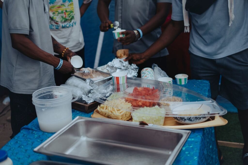 Local Ghanaian meal and drinks on an outdoor table in the evening