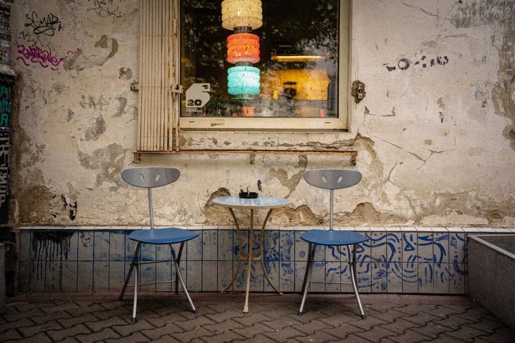 Small table for two by a window in a modest café