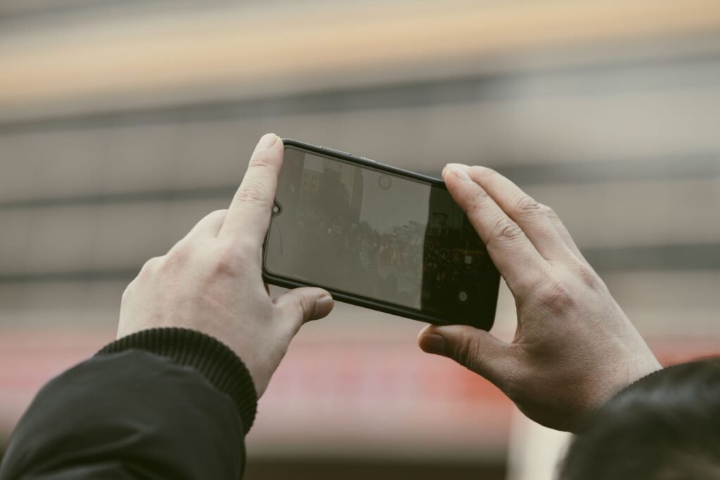 A person reviewing a blurred social media feed on a phone, illustrating post-date privacy checks