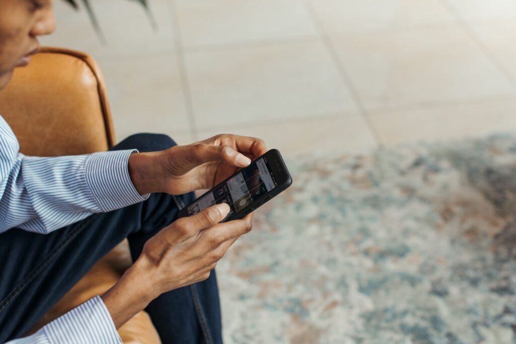 Person browsing an online directory on a smartphone indoors