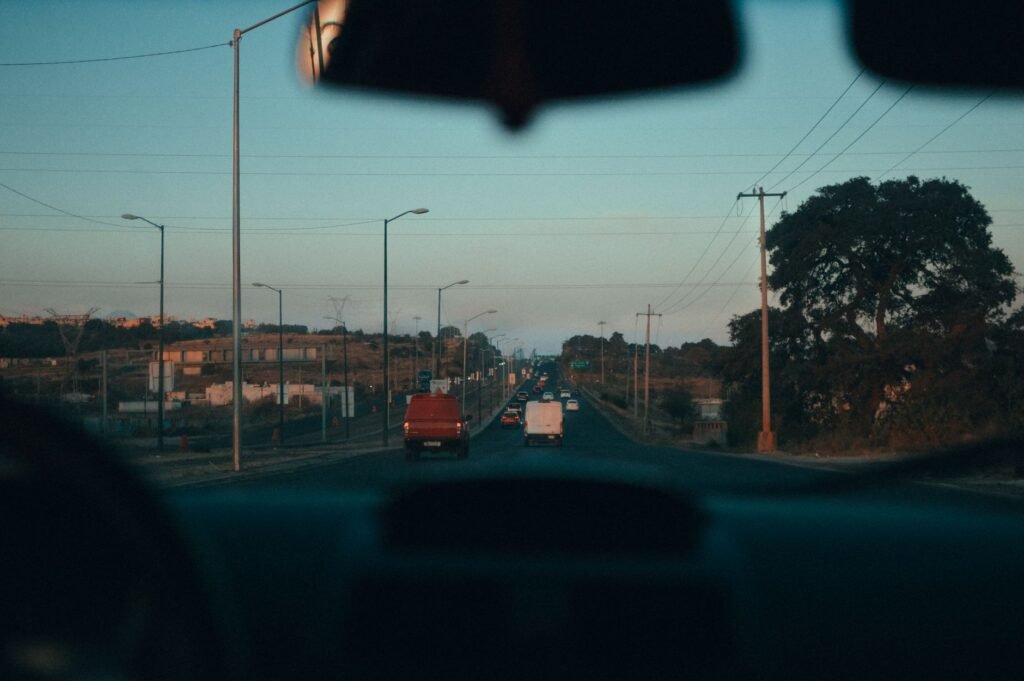 Car waiting on a quiet residential road at dusk