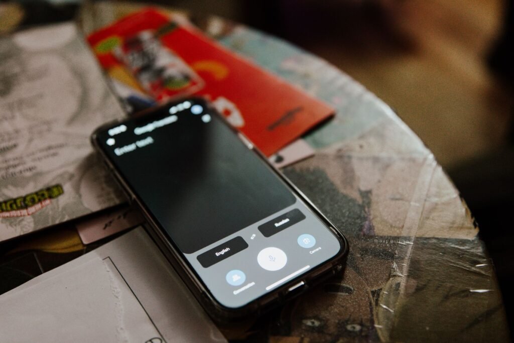 A smartphone on a desk used to browse a directory and message a contact