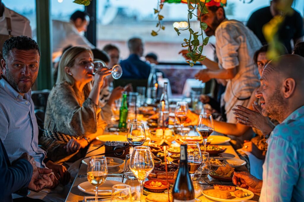 Shared plates and place settings on a restaurant table in warm evening light