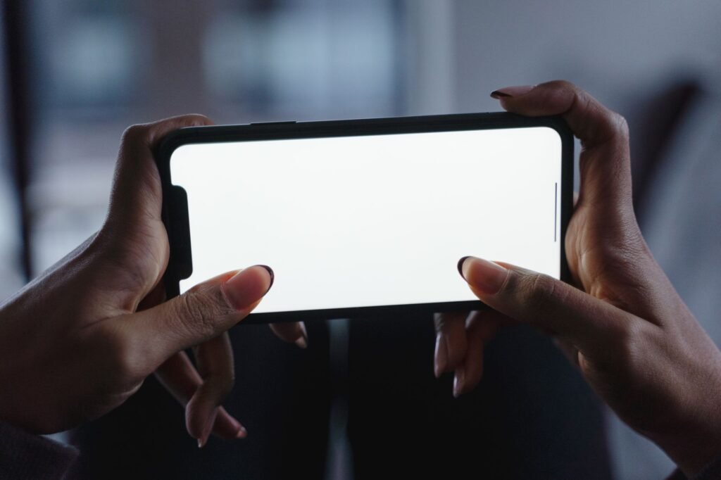 Person reviewing a directory listing on a smartphone indoors