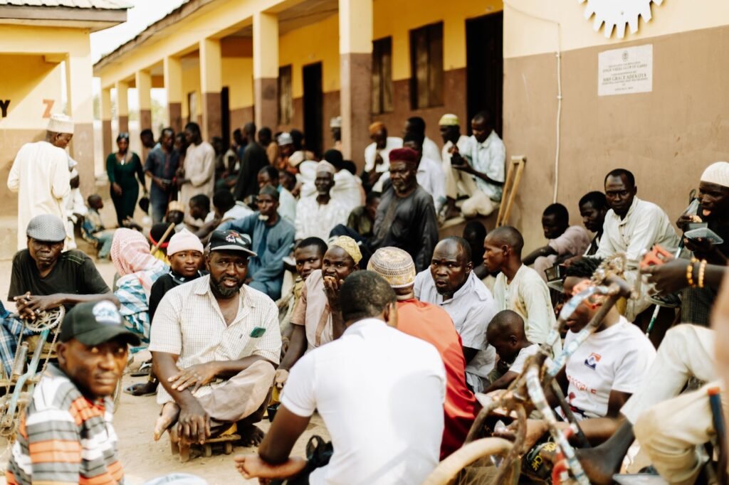 A bustling outdoor meeting with diverse group at a community center