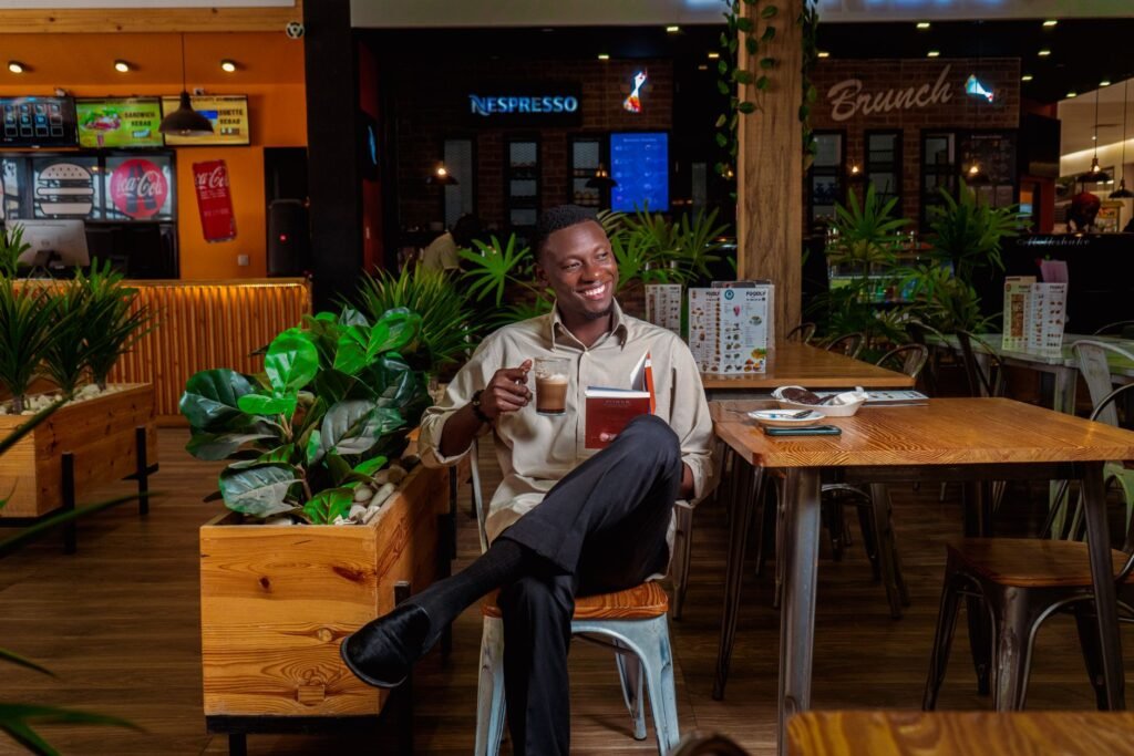 Man enjoying coffee and a book in a cozy café setting.