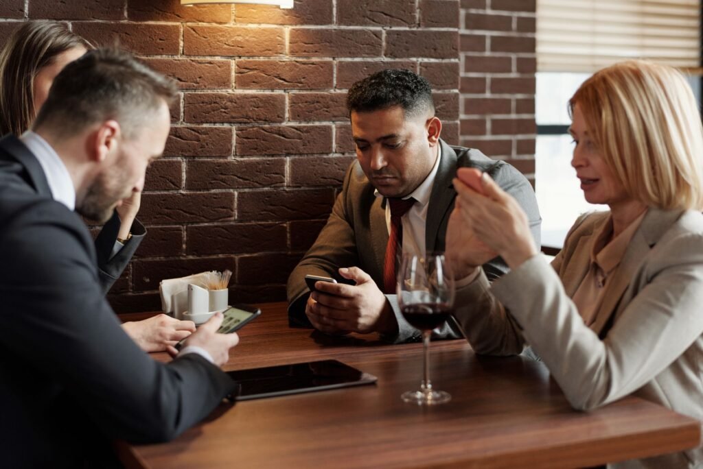 Two phones and coffee cups on a cafe table during a conversation