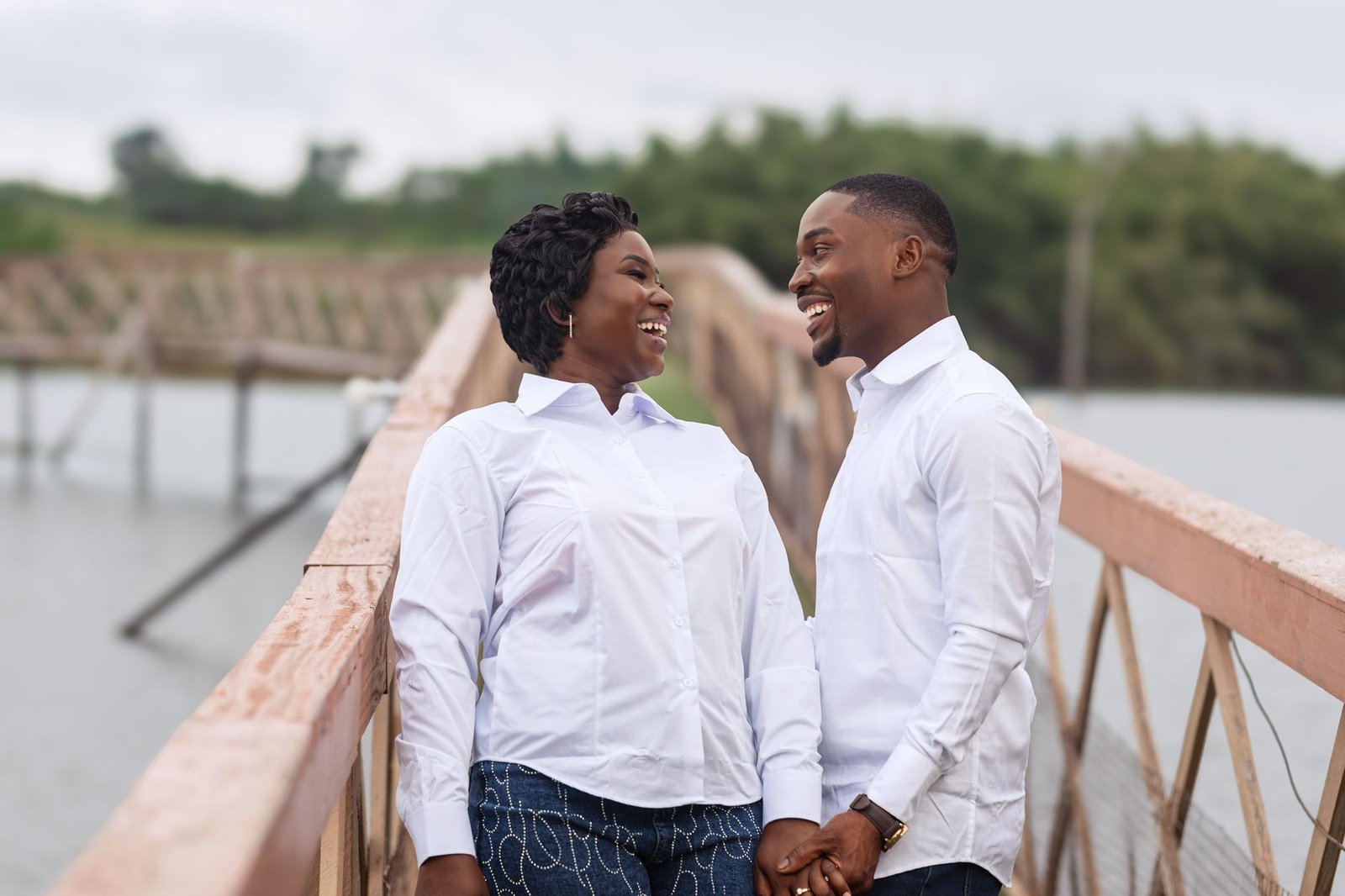Happy couple on a bridge in Accra, Ghana sharing a joyful moment.