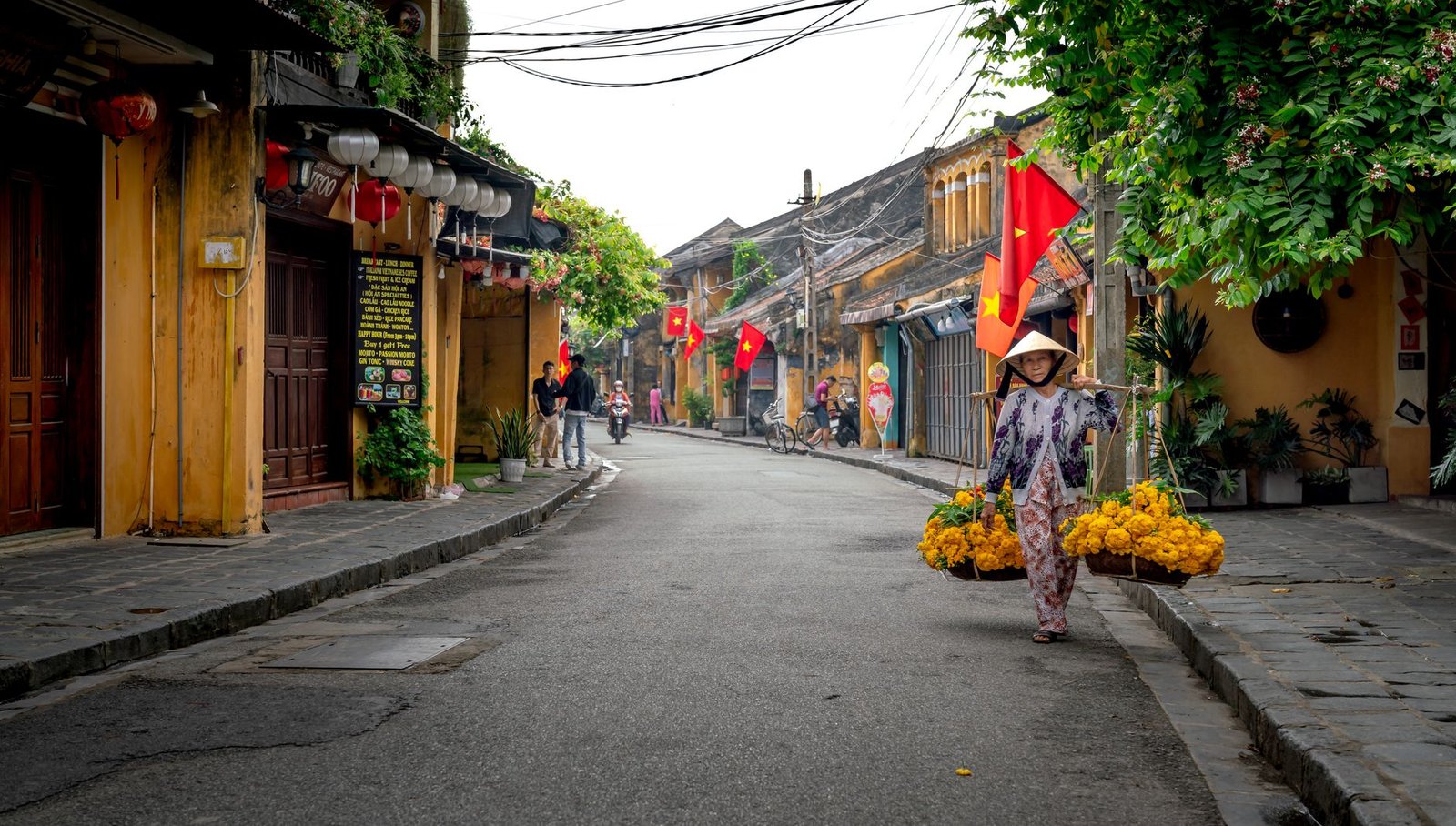 A vibrant street scene in Vietnam featuring a woman carrying flowers in Ho Chi Minh City.