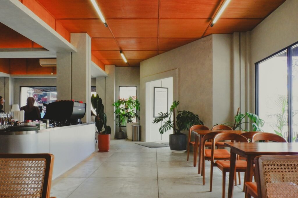 Stylish modern cafe interior featuring wooden elements and natural lighting in Jawa Barat, Indonesia.