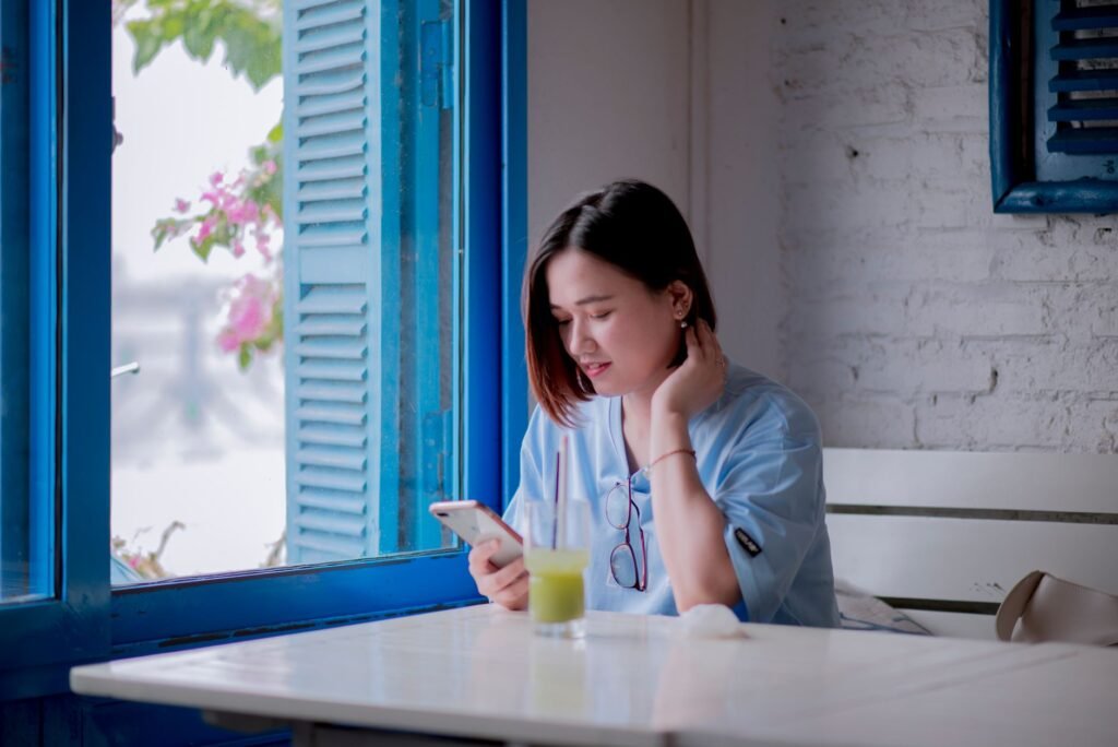 Person reading a directory listing on a smartphone indoors