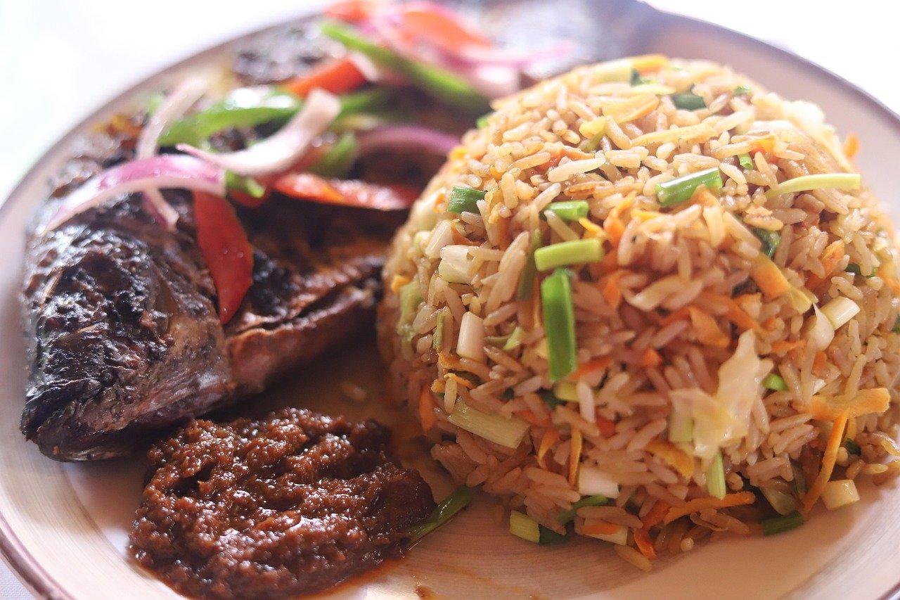 jollof, jollof rice, ghanaian dishes, rice and tilapia, jollof rice and tilapia, grilled tilapia, rice and fish, jollof rice