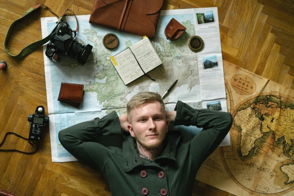 Traveller planning a trip with a map and phone in a guesthouse room