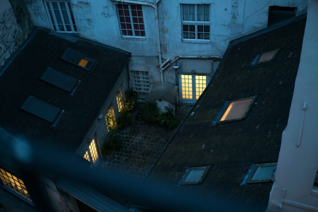 Quiet guesthouse courtyard at dusk with warm low lighting