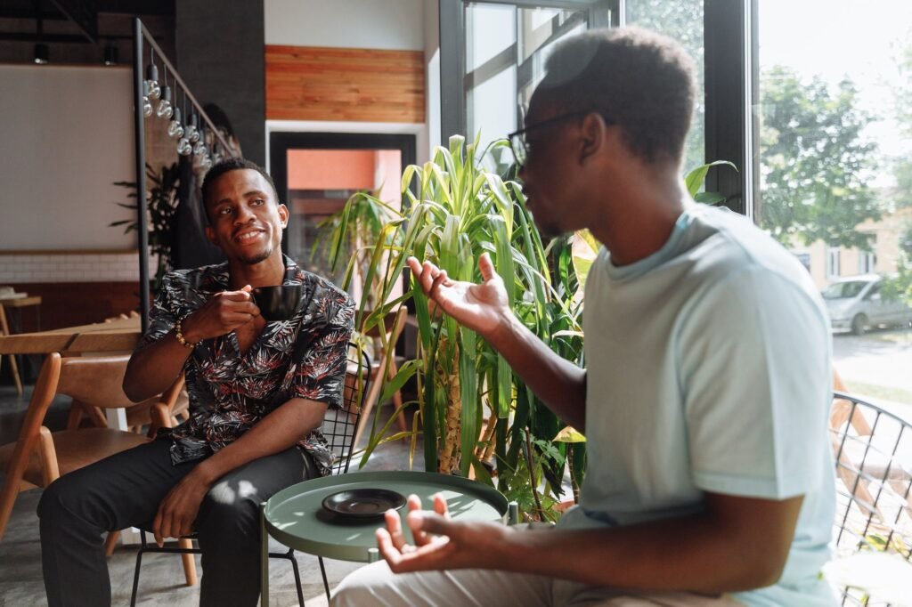Two people having a relaxed conversation in a simple setting