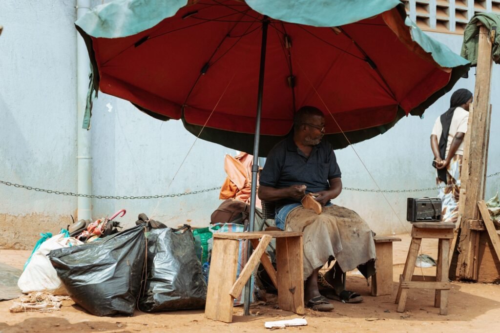 Shared taxis and trotro at a small Ghanaian lorry station