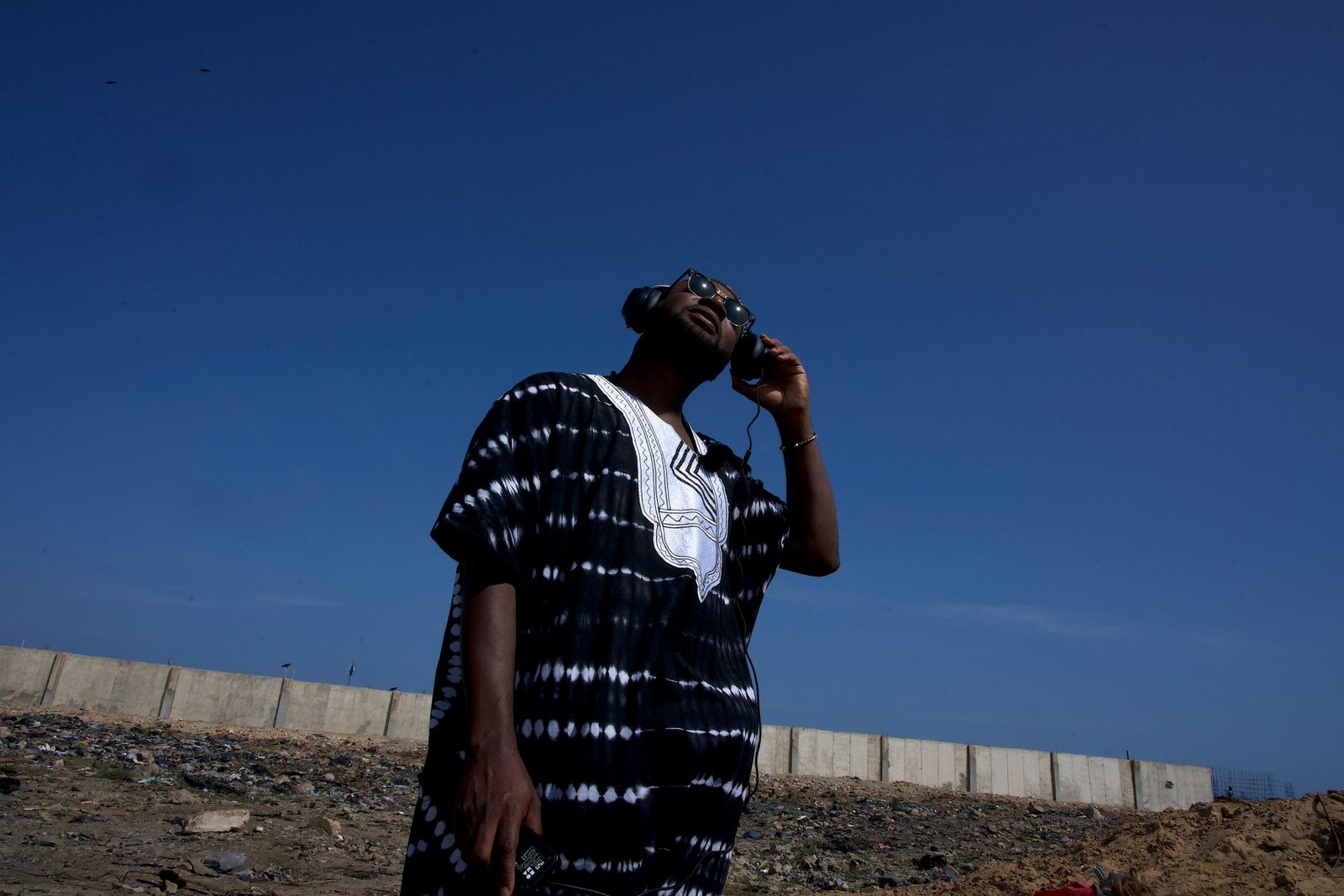Adult visitor discreetly checking travel information on a smartphone in East Legon
