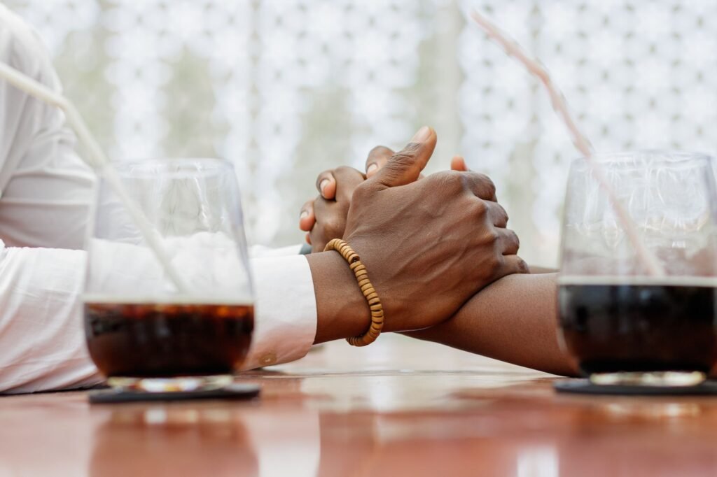 Two people in relaxed conversation at an outdoor table
