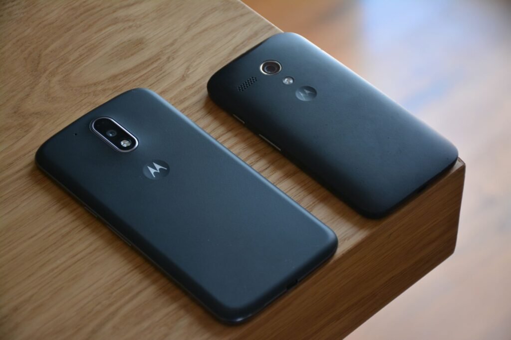 Two smartphones on a table by a window, representing clear and courteous booking communication
