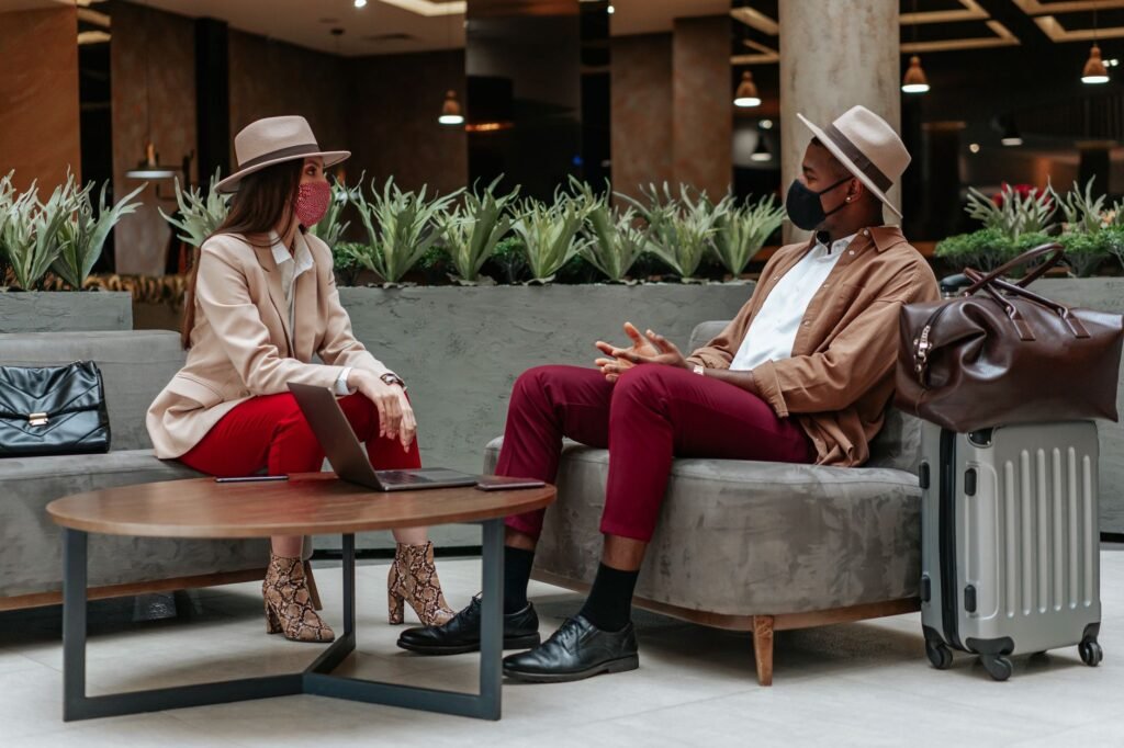 Two people in respectful conversation in a hotel lobby