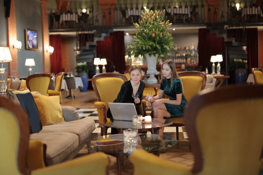 Two adults in quiet conversation at a hotel lounge table