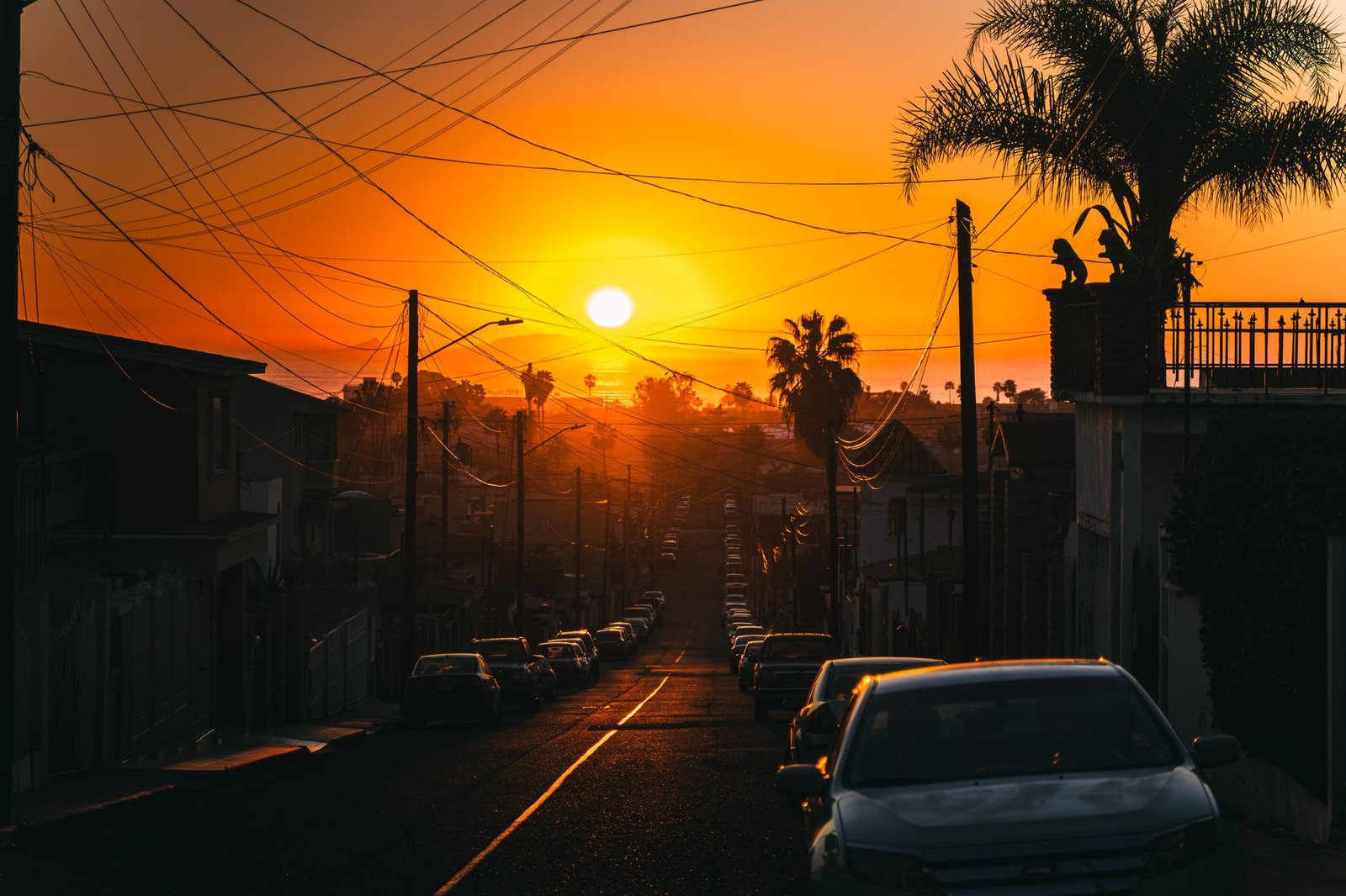 Quiet residential street in East Legon, Accra at dusk with warm street lighting
