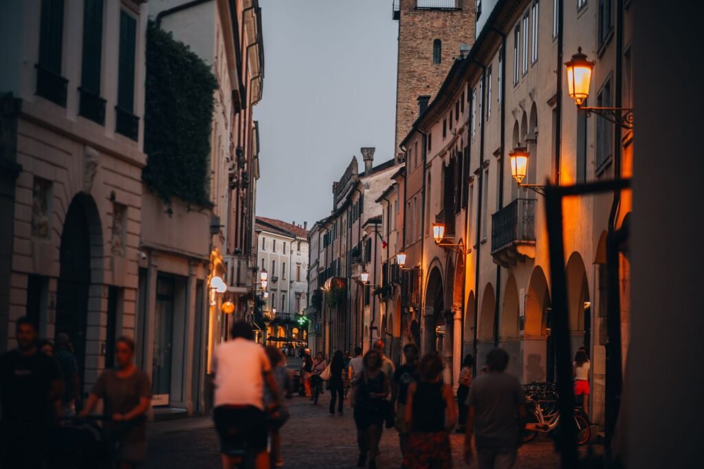 Small Ghanaian town street at dusk where a discreet meeting might begin