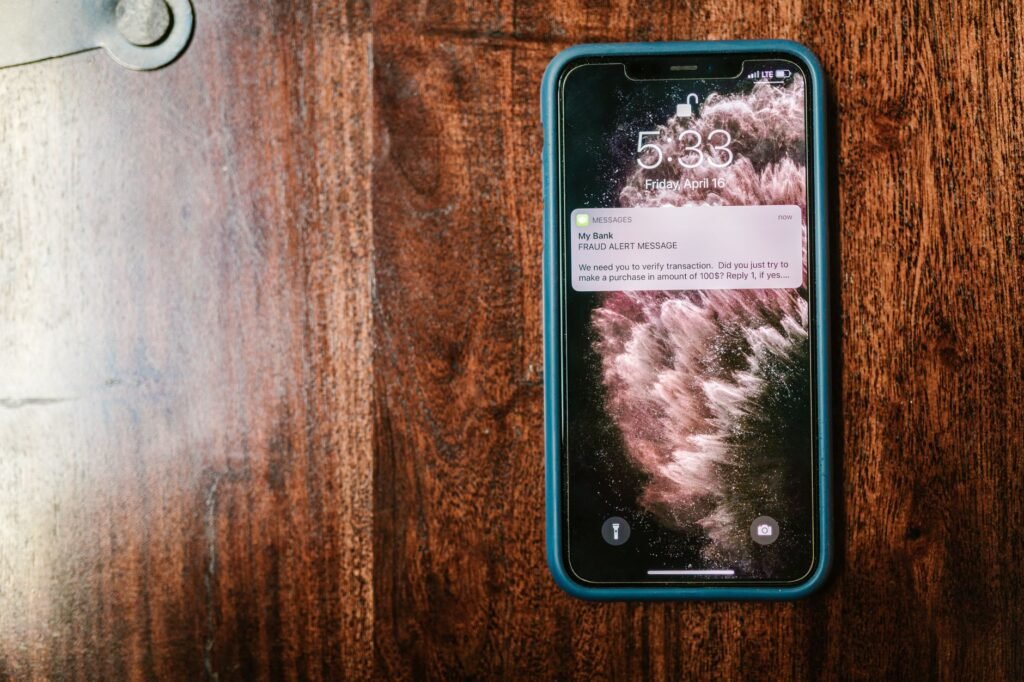 Smartphone on a table beside a cup of tea, used to illustrate polite first contact messages