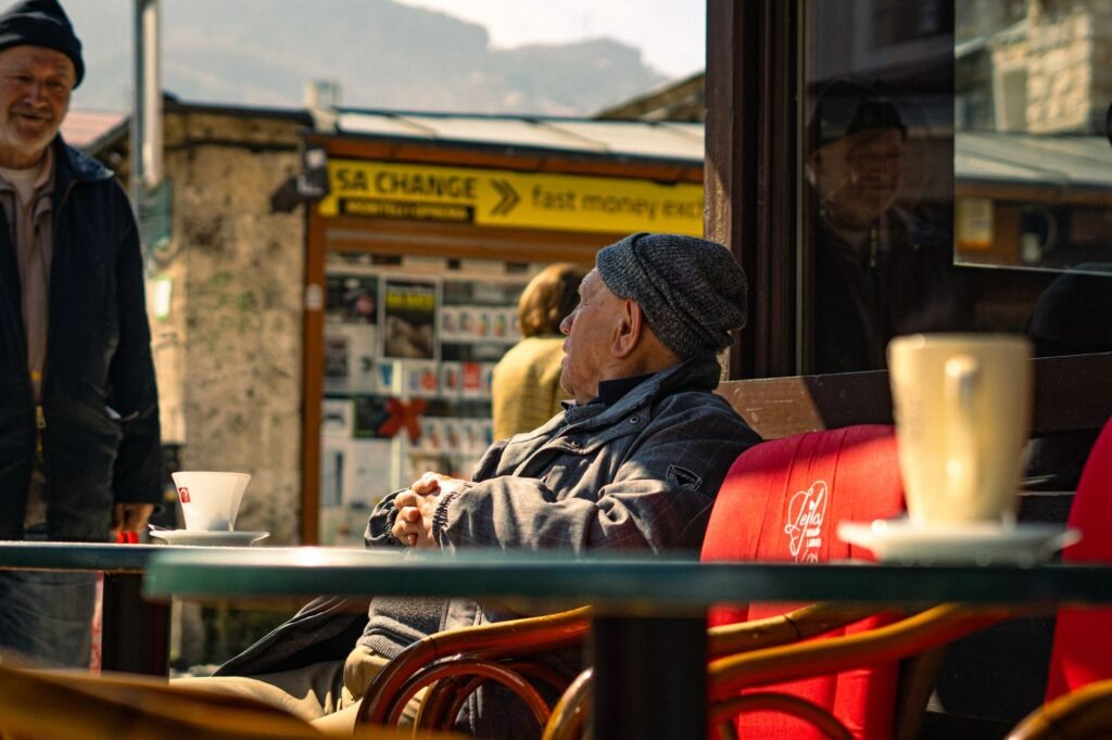Two people having a calm, respectful conversation at an outdoor cafe