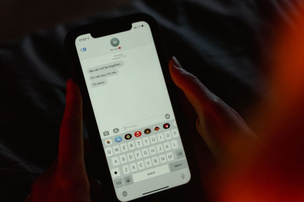 Person holding a smartphone and composing a polite confirmation message
