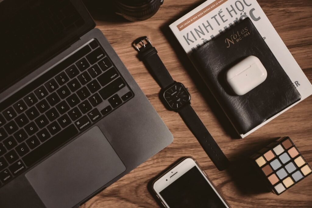 Wristwatch and notebook on a table, representing punctuality and planning