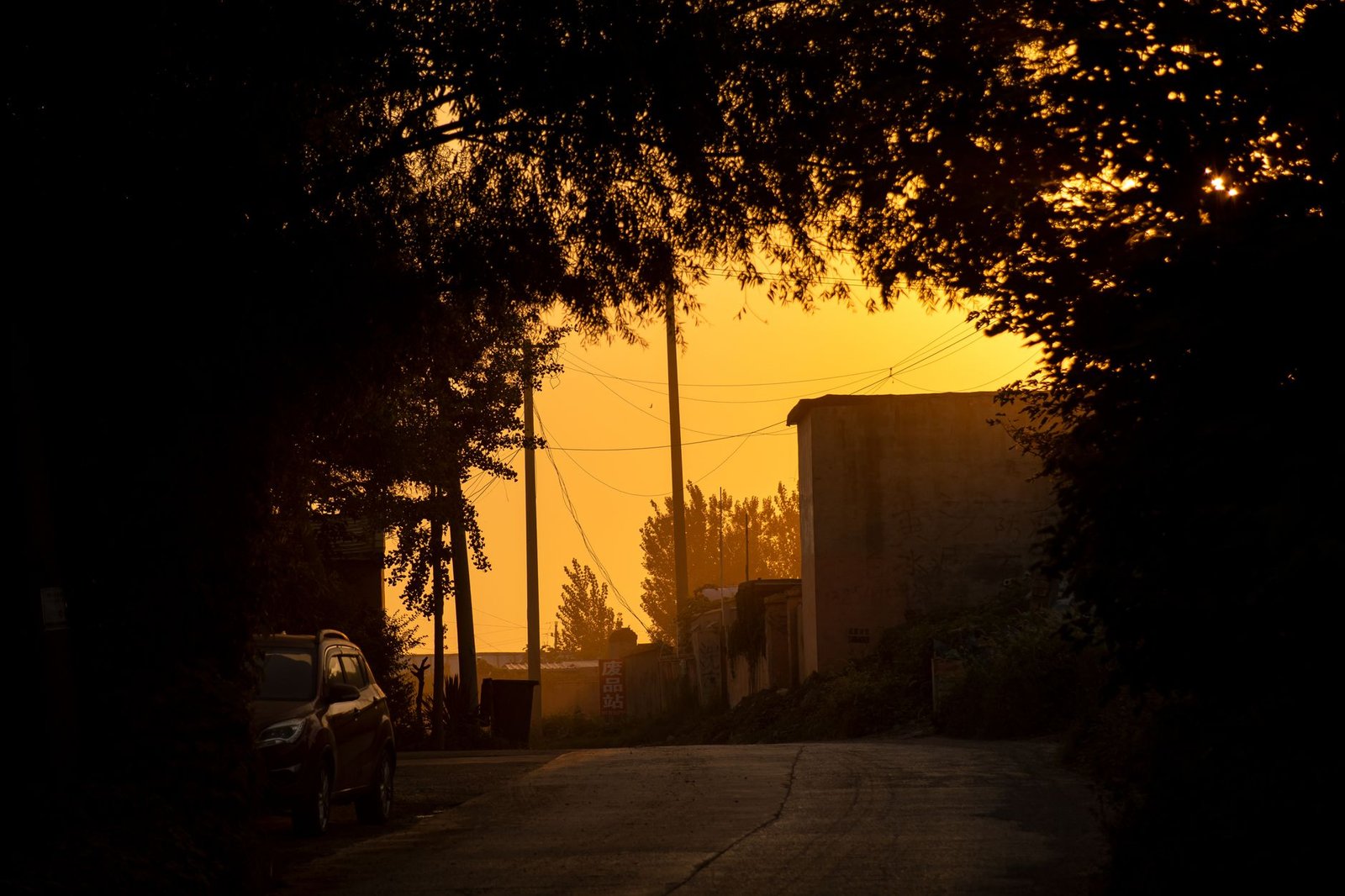 Quiet roadside town in the Ahafo Region of Ghana at golden hour