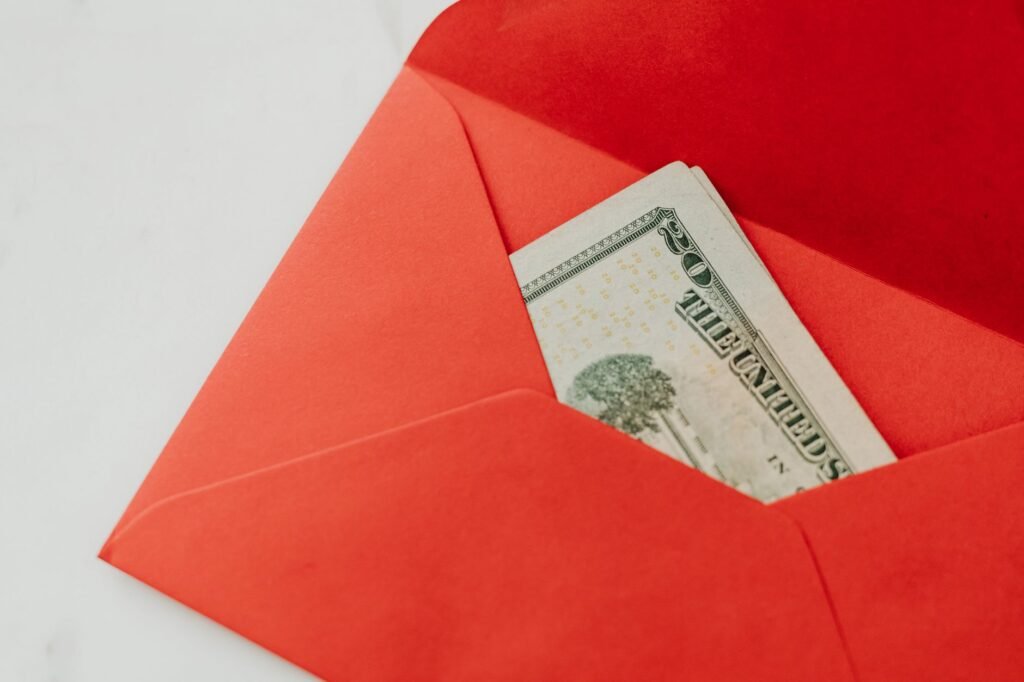 Hands placing cash into an envelope for discreet payment