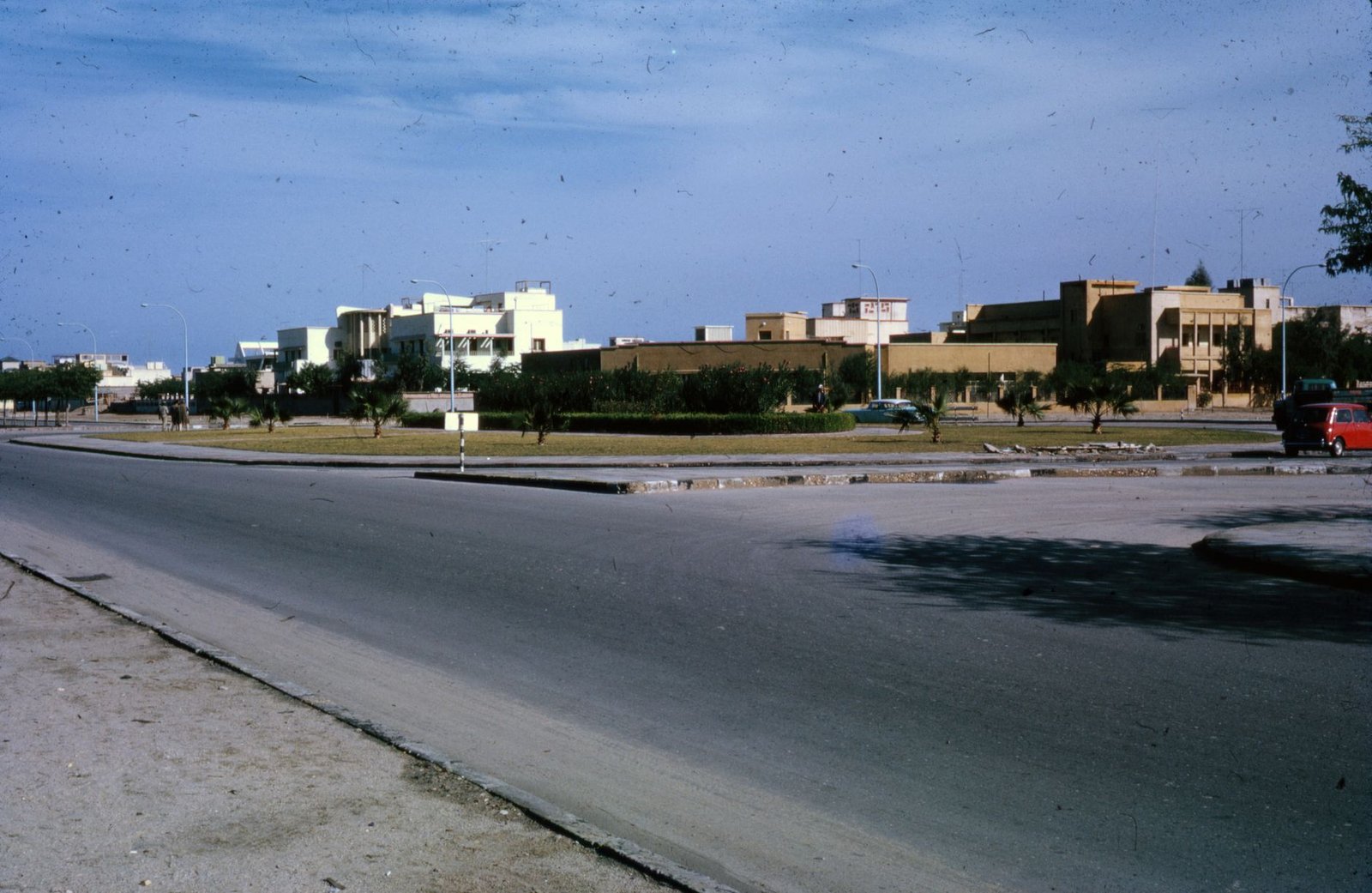 A nostalgic view of a Middle Eastern street with vintage architecture and clear blue skies.