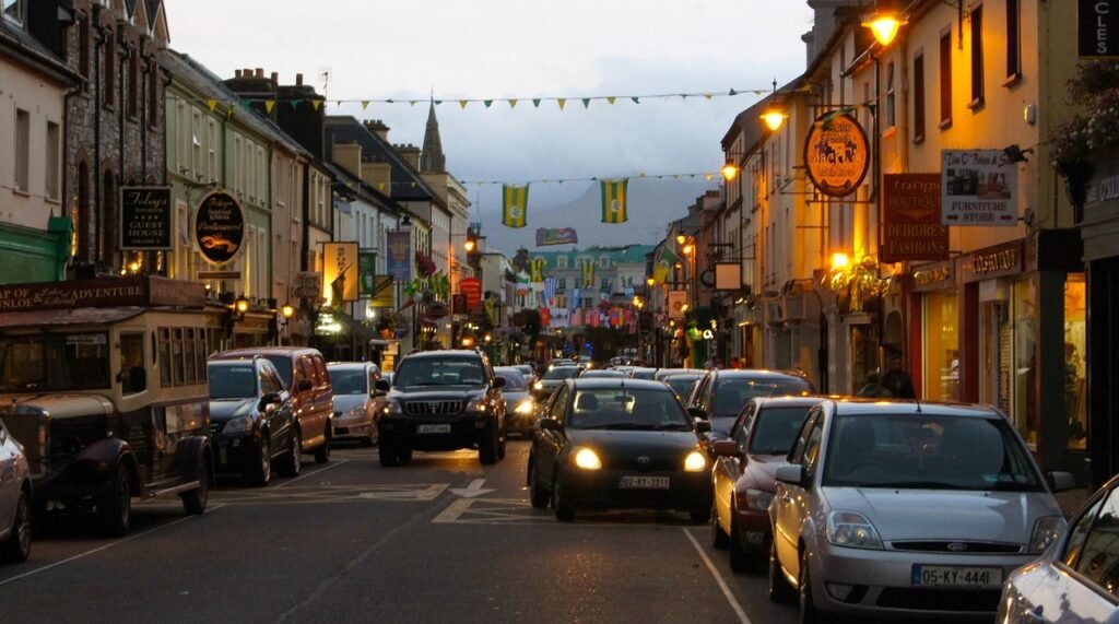 killarney, ireland, city, traffic, shops, downtown, street, road, urban, shopping, travel, scene, town, brown road, brown sho