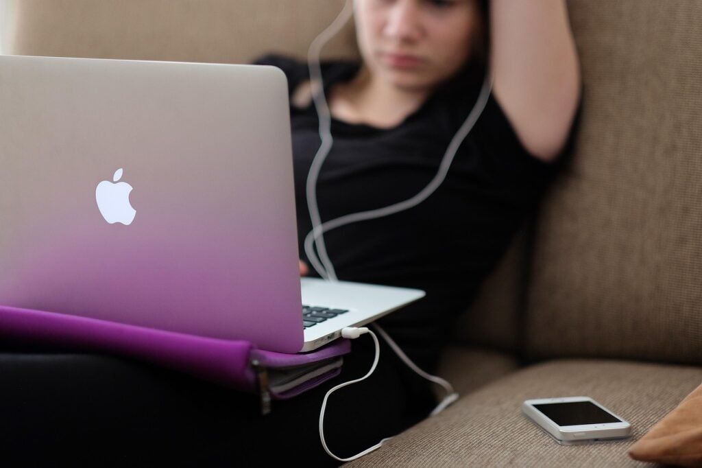 apple, computer, girl, iphone, working, laptop, macbook air, woman, couch, sit, sitting, macbook, apple products, work from h