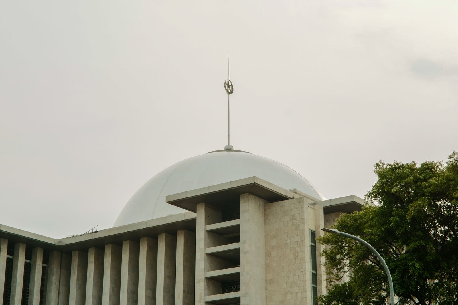 View of Istiqlal Mosque's grand dome and architecture in Jakarta, Indonesia.